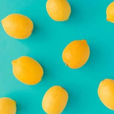 Creative summer pattern made of lemons on bright blue background